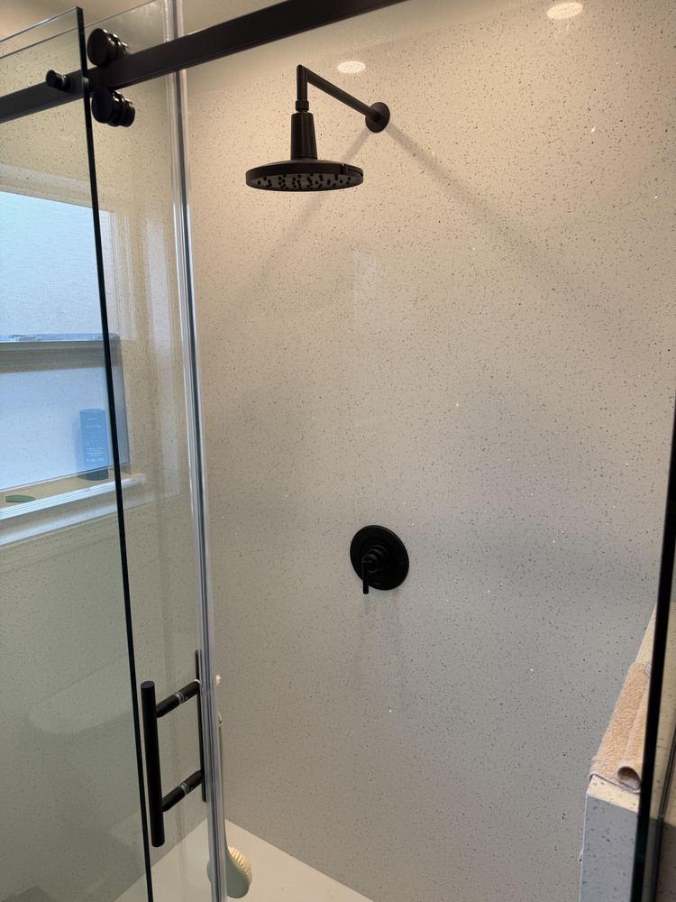Matte black rain showerhead in bright walk-in shower by Righteous Renovations in Salem, OR custom home