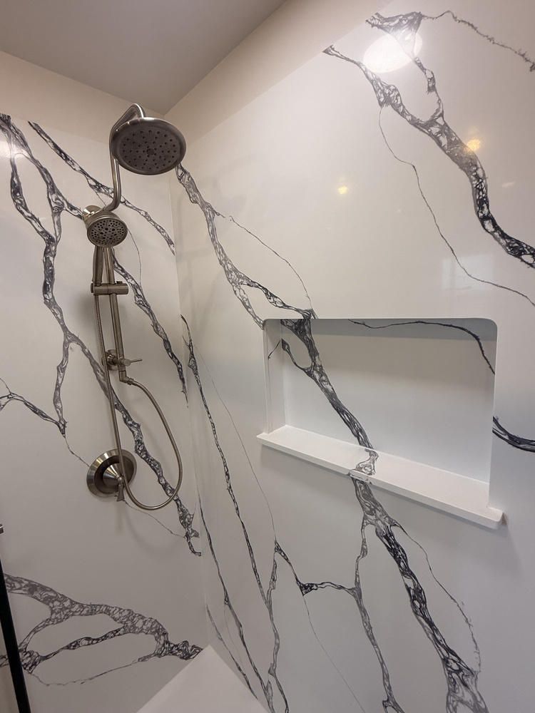 Contemporary custom home shower with black and white veined walls and brushed nickel hardware by Righteous Renovations in Salem, OR