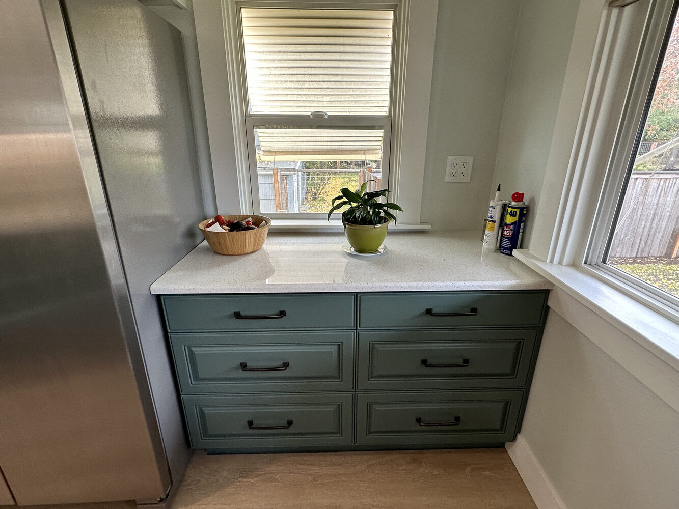 Compact kitchen nook with six-drawer storage and natural light by Righteous Renovations in Salem, OR
