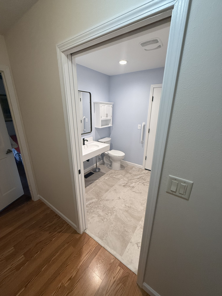 Salem custom home bathroom with stacked laundry and fiberglass shower enclosure by Righteous Renovations