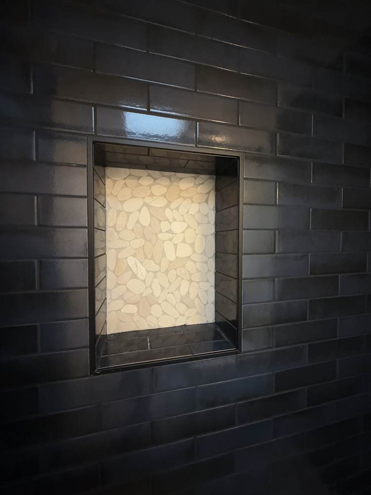Close-up of textured tile niche in custom shower remodel by Righteous Renovations in Salem, Oregon