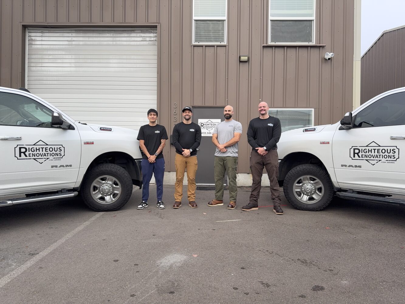 Righteous Renovations custom home team standing in front of their Salem, OR headquarters with branded trucks