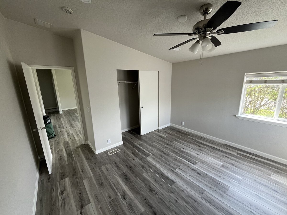 Custom bedroom renovation with gray wood-look flooring by Righteous Renovations in Salem, OR