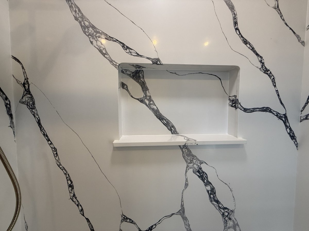 Close-up of built-in shower niche with black veined wall finish by Righteous Renovations in a Salem, OR custom home