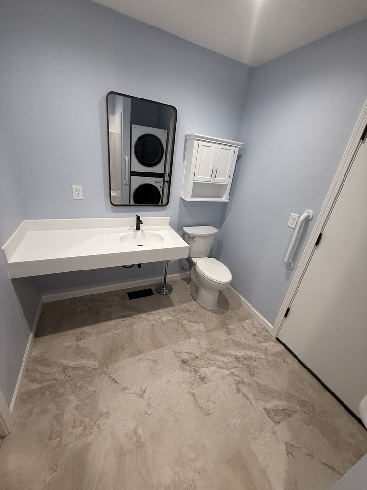 Bathroom renovation with floating vanity, modern toilet, and grab bars by Righteous Renovations near Salem, OR