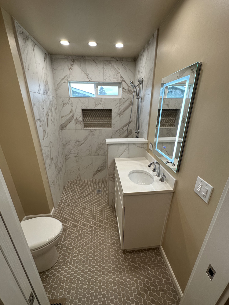 Elegant custom shower and vanity combo with neutral tones and LED lighting by Righteous Renovations in Salem, OR