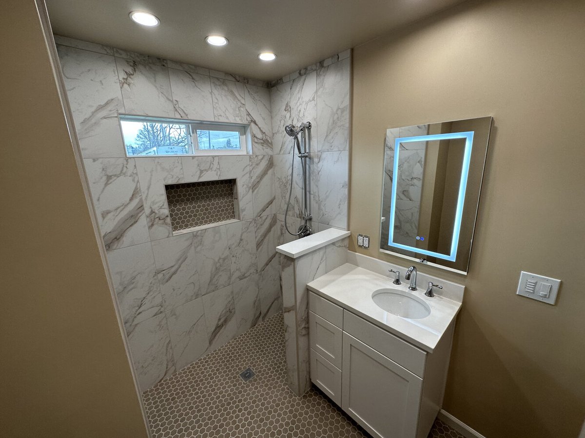 Vanity with LED mirror and walk-in shower remodel in a custom home by Righteous Renovations in Salem, Oregon