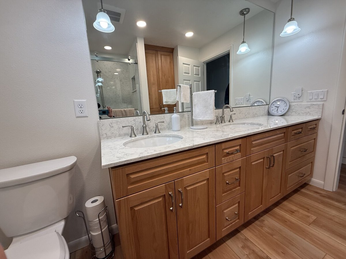 Custom vanity with dual sinks and pendant lighting by Righteous Renovations in Lebanon, OR