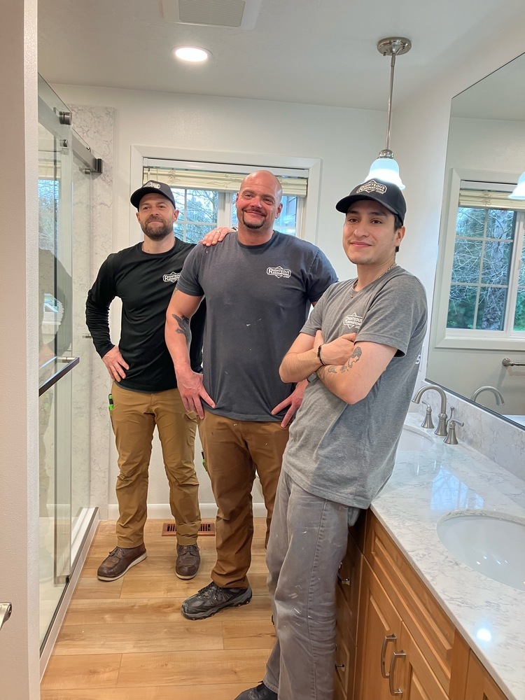 Friendly remodeling crew from Righteous Renovations inside a completed bathroom project in Independence, OR