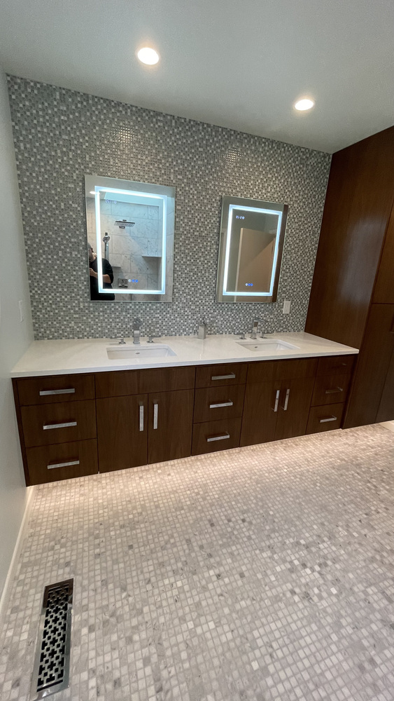 Contemporary double vanity with LED mirrors and sleek cabinetry by Righteous Renovations in a custom home in Sherwood, OR