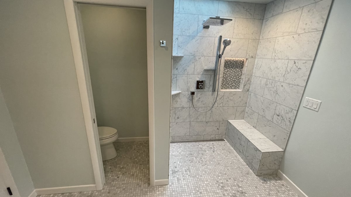 Open concept shower and toilet area in a custom bathroom remodel by Righteous Renovations in Oregon City, OR