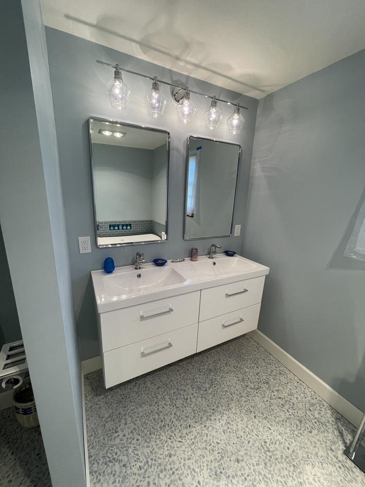 Double sink vanity with chrome fixtures in a custom home bathroom by Righteous Renovations in Salem, OR