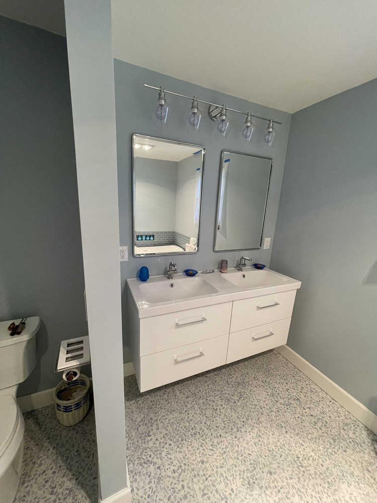 Twin sink setup with overhead lighting in custom bathroom by Righteous Renovations in Salem, OR