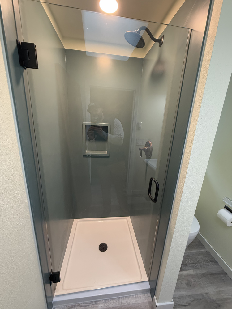 Custom walk-in shower and minimalist toilet layout in Salem, OR home by Righteous Renovations