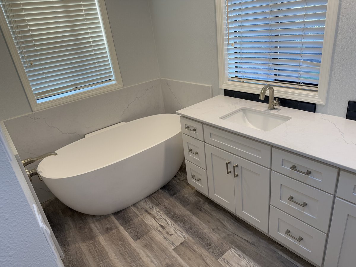 Freestanding tub and custom vanity with quartz countertop by Righteous Renovations in Salem, OR
