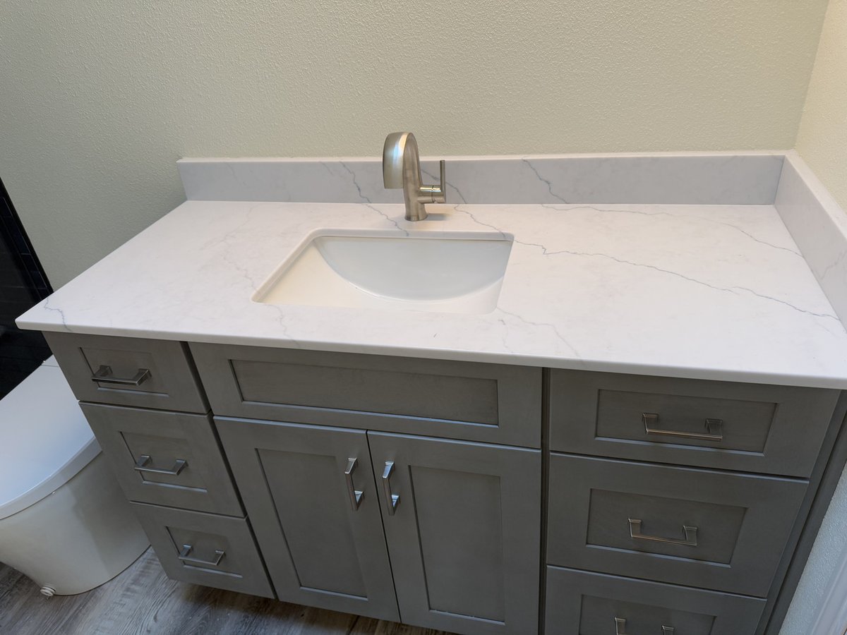 Gray vanity with marble countertop in custom bathroom renovation by Righteous Renovations in Salem, OR