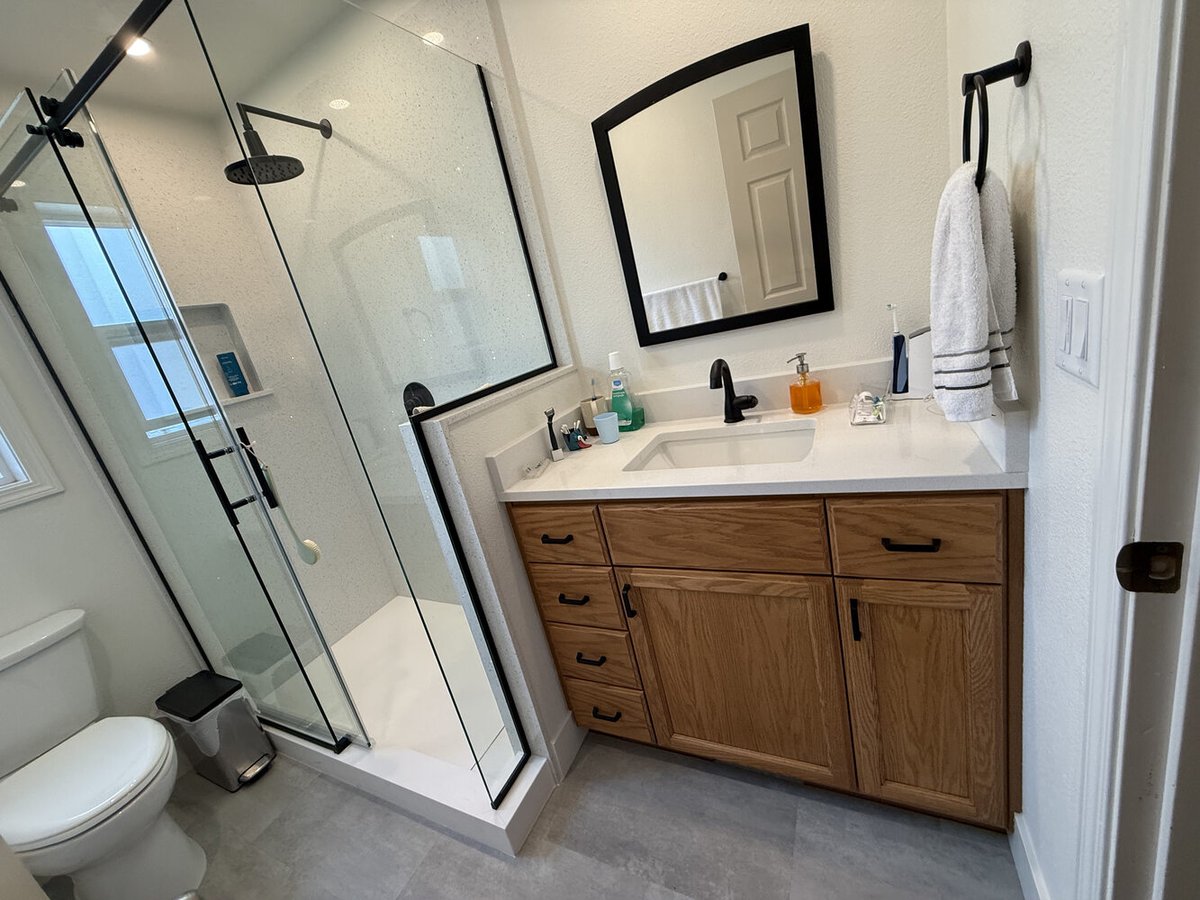 Complete custom bathroom with walk-in shower and oak vanity by Righteous Renovations in Salem, OR