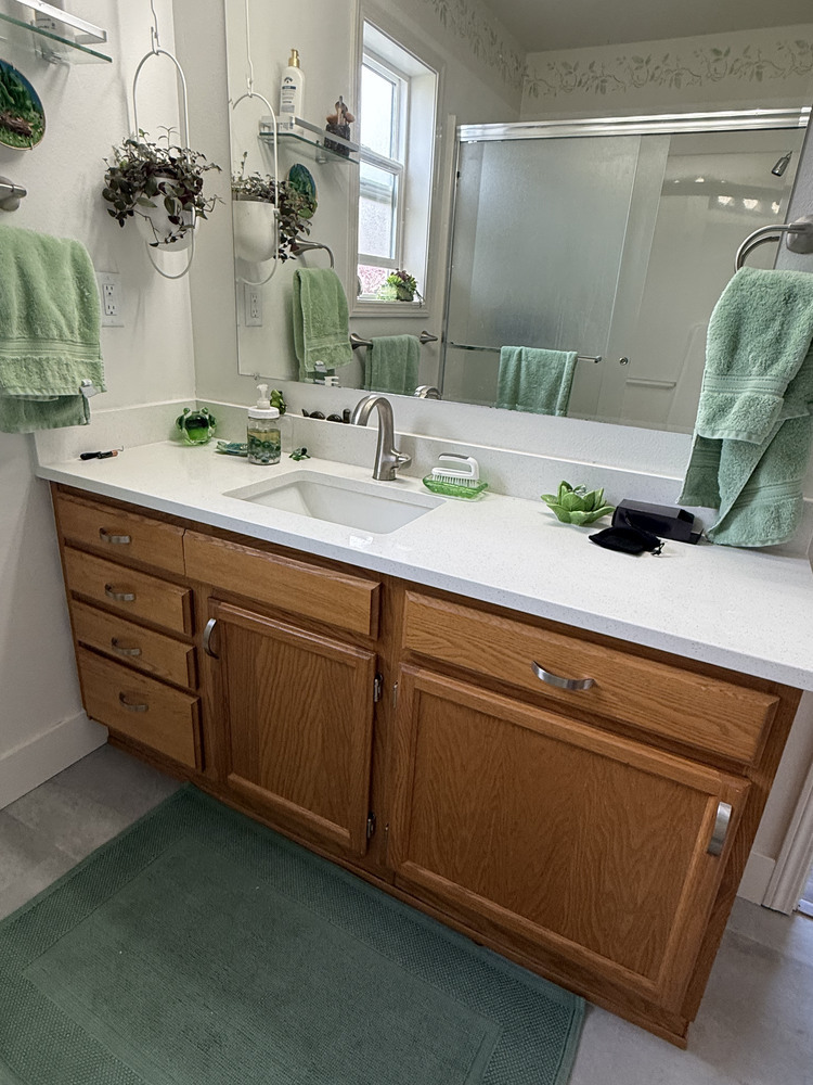 Custom bathroom remodel with white quartz counter and green decor by Righteous Renovations in Salem, Oregon