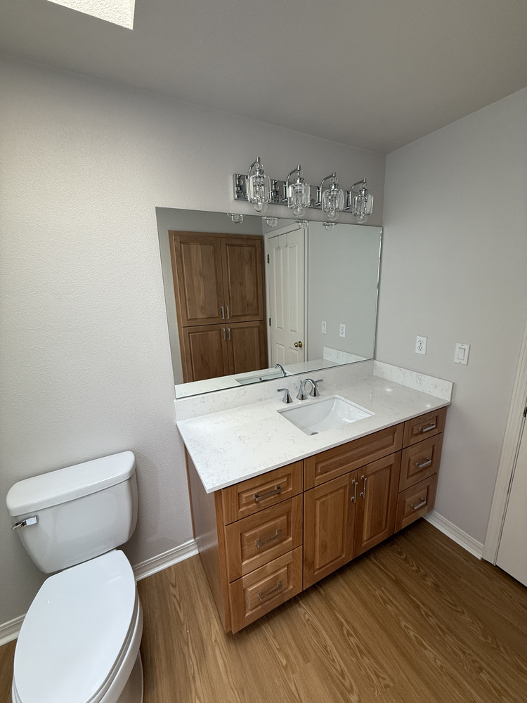Custom bathroom vanity with wood cabinetry and quartz countertop in a Salem, OR home by Righteous Renovations