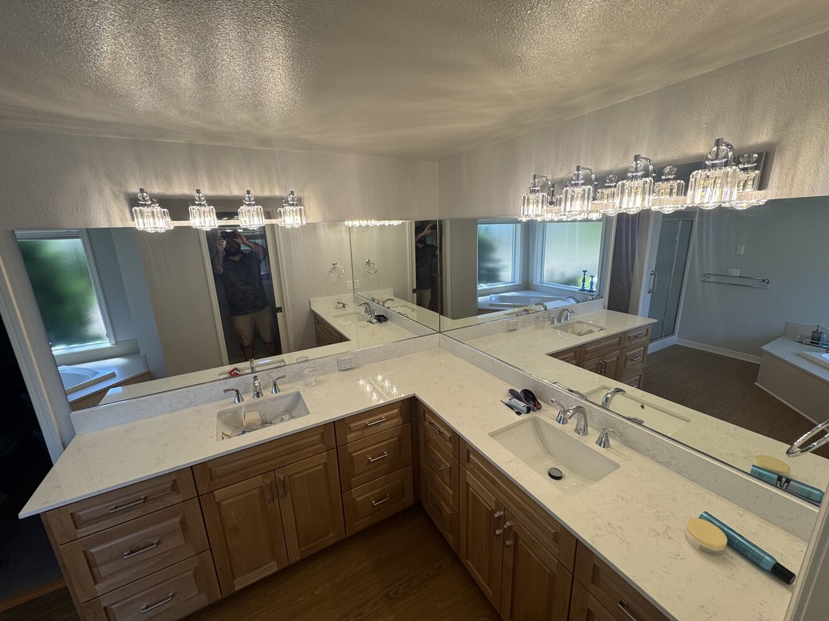 Dual-sink vanity with quartz counters and full-length mirrors in a Salem, OR custom home by Righteous Renovations