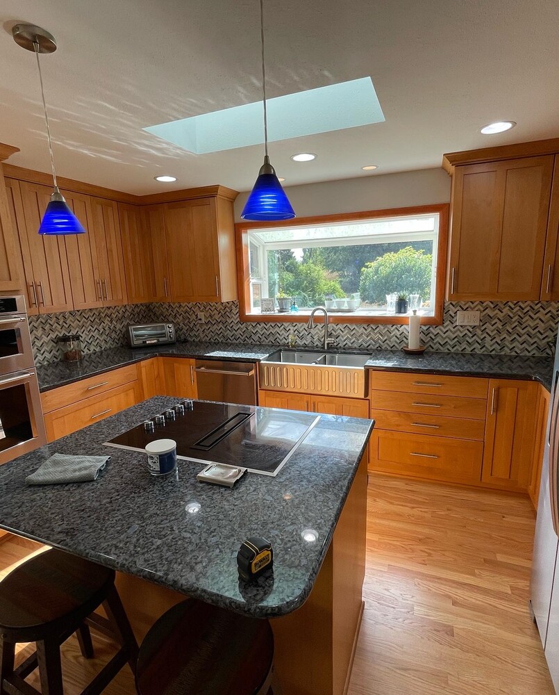 Modern kitchen remodel with wood cabinetry and granite countertops by Righteous Renovations in Salem, OR