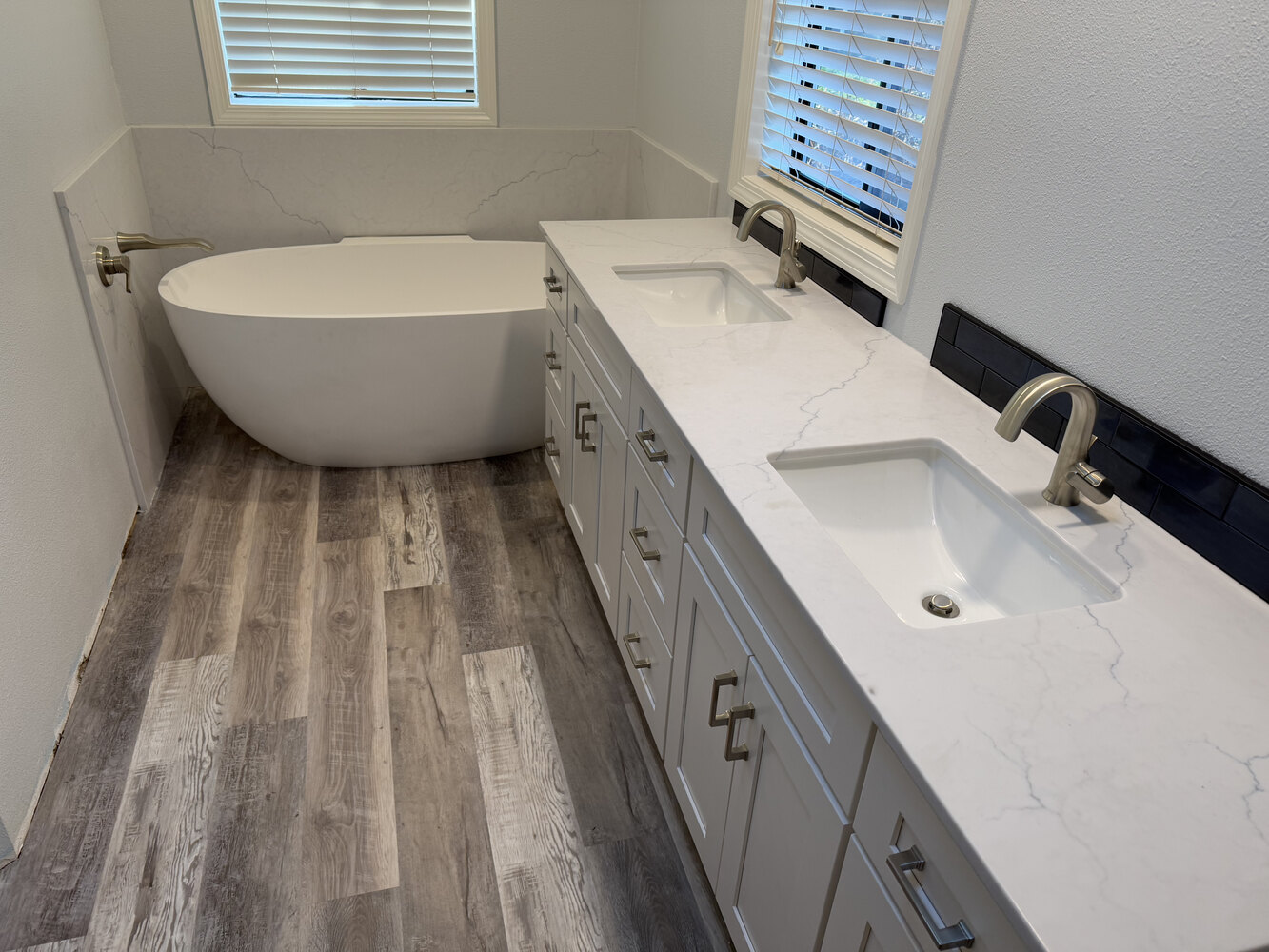 Dual sink vanity and soaking tub in custom home bathroom by Righteous Renovations in Salem, OR