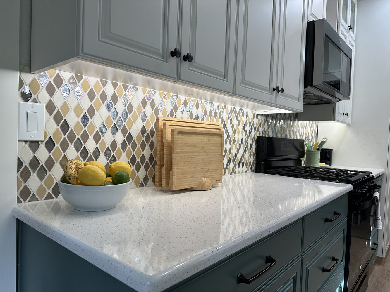 Close-up of kitchen backsplash with diamond pattern tiles and white quartz countertop by Righteous Renovations in Salem, OR
